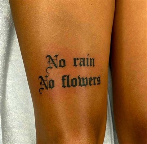 No rain no flowers tattoo thigh